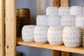 Close up many groups of handmade wooden vase stock on the shelf at the vase store. Vase stock is ready for delivery.