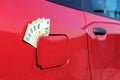 Close up of many hundred euro banknotes in the gas cap of a car Royalty Free Stock Photo