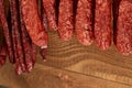 Close up on many natural sausage hanged on wooden background Royalty Free Stock Photo