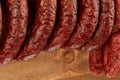 Close up on many natural sausage hanged on wooden background Royalty Free Stock Photo