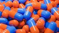 Close up of many orange and blue pills capsules. Medicine and pharmacy concept.,3d model and illustration Royalty Free Stock Photo