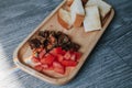 Close-up many pieces of crispy bread toast with roast dice pork and slice tomato served on wooden trey in coffee shop.A delicious Royalty Free Stock Photo