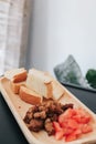 Close-up many pieces of crispy bread toast with roast dice pork and slice tomato served on wooden trey in coffee shop.A delicious Royalty Free Stock Photo