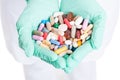 Close-up of many pills, capsules and tablets in doctor hands