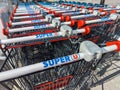 Close-up of many shopping carts marked with the logo of a Super U supermarket, Veynes, France