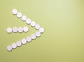 Close up of many white pills on yellow background Royalty Free Stock Photo