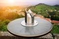 Close-up of marble toposcope with italian toscana landscape. Direction Indicator. Navigation system. Sunset time. Travel concept