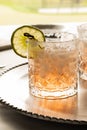 Close up of a margarita mocktail garnished with a slice of lime and a salted rim, against a bright sunny background. Royalty Free Stock Photo