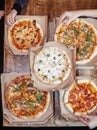 Close-up of Margarita pizza in a disposable dish. Top view of takeaway food in a fast food cafe. On photo - mozzarella cheese, Royalty Free Stock Photo