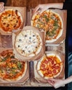 Close-up of Margarita pizza in a disposable dish. Top view of takeaway food in a fast food cafe. On photo - mozzarella cheese, Royalty Free Stock Photo