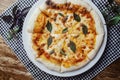 Close-up of Margarita pizza in a disposable dish. Top view of takeaway food in a fast food cafe. On photo - mozzarella cheese, Royalty Free Stock Photo