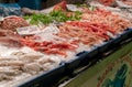 close-up of market stall with fresh squid and shrimps on crushed ice