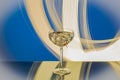 Close-up of martini glass with ice against blue-white abstract backdrop Royalty Free Stock Photo