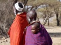 Close up of Masai mum and dad walking away with baby on back, Tanzania