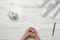 Close-up masculine folded hands on wooden panel with hand-folding a piece of paper Royalty Free Stock Photo