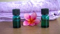 Close up of massage oil and pink frangipani flowers on a wooden table Royalty Free Stock Photo