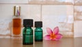 Close up of massage oil and pink frangipani flowers on a wooden table Royalty Free Stock Photo