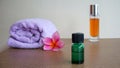 Close up of massage oil and pink frangipani flowers on a wooden table Royalty Free Stock Photo