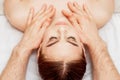 Massage therapist`s hands doing massage on head Royalty Free Stock Photo