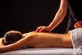 Close-up masseur hands doing back massage to female client in spa center Royalty Free Stock Photo