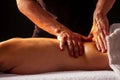 Close-up masseur hands doing back massage to female client in spa center Royalty Free Stock Photo