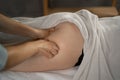 Close-up of masseur hands doing legs massage. Healing Massage and body care. Young woman getting spa massage treatment Royalty Free Stock Photo