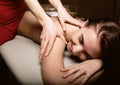 Close-up masseur hands doing spin massage, relaxed patient enjoys Royalty Free Stock Photo