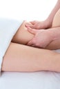 Close up of a masseur massaging woman`s legs