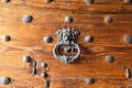 Wooden door with ornate iron door knocker Royalty Free Stock Photo