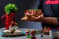 Close up master chef hands making a delicious strawberry tarts. Fruit dessert tarts with cheese cream Royalty Free Stock Photo