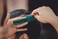 Close-up master hairdresser does hairstyle with scissors and comb. Concept Barbershop Royalty Free Stock Photo