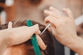 Close-up master hairdresser does hairstyle with scissors and comb. Concept Barbershop Royalty Free Stock Photo