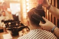 Close-up master hairdresser does hairstyle with scissors and comb. Concept Barbershop Royalty Free Stock Photo