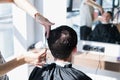 Close-up, master hairdresser does hairstyle and style with scissors and comb. Concept Barbershop. Royalty Free Stock Photo