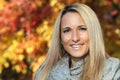 Close up Of A Mature Blond Woman Smiling At The Camera. Fall