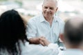 mature businessman confidently shaking hands with his business partner. Royalty Free Stock Photo