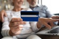 Close up mature couple paying online by plastic credit card