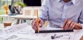 Close Up Of Mature Male Architect Working In Office At Desk Studying Plans For New Building Royalty Free Stock Photo