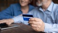 Close up mature man holding credit card, couple paying online Royalty Free Stock Photo