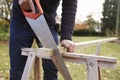 Close Up Of Mature Man Sawing Wood Outdoors Royalty Free Stock Photo