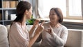 Close up mature mother and grownup daughter speaking sign language Royalty Free Stock Photo