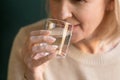 Close up of elderly woman drinking pure mineral water Royalty Free Stock Photo