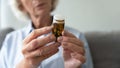 Close up of old woman taking prescribed medicines at home Royalty Free Stock Photo