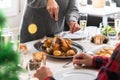 Close up of mature woman carving Christmas chicken.