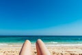 Mature woman legs sunbathing on the beach Royalty Free Stock Photo