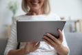 Close up of mature woman using modern tablet gadget Royalty Free Stock Photo