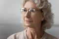 Close up of mature woman wearing modern round glasses