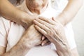 Close up of mature womans & nurse hands. Health care giving, nursing home. Parental love of grandmother. Old age related diseases. Royalty Free Stock Photo