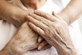 Close up of mature womans & nurse hands. Health care giving, nursing home. Parental love of grandmother. Old age related diseases. Royalty Free Stock Photo