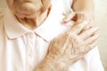 Close up of mature womans & nurse hands. Health care giving, nursing home. Parental love of grandmother. Old age related diseases. Royalty Free Stock Photo